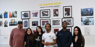 Group poses for photograph at an exhibition