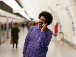 man on mobile in Tube station