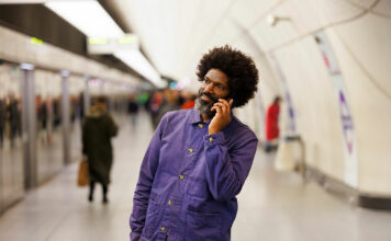 man on mobile in Tube station