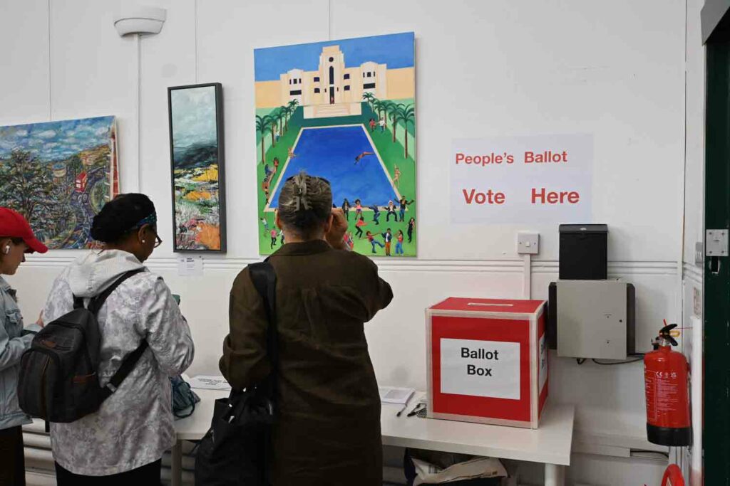 people at an artshow with ballot box