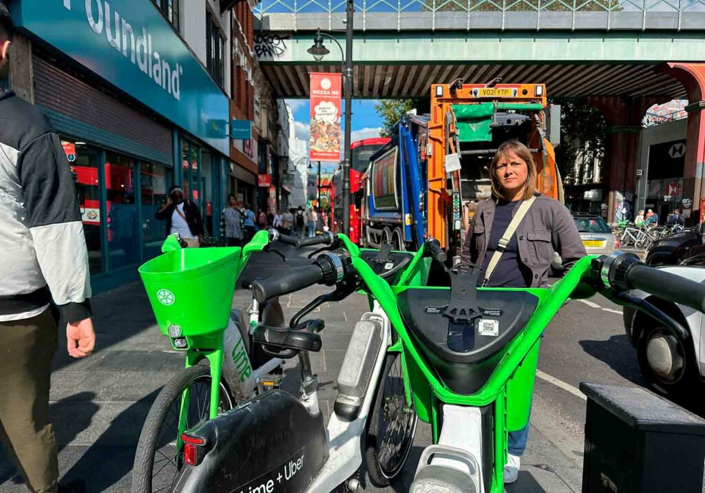 Woman poses for photo with e-bikes