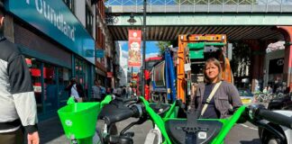 Woman poses for photo with e-bikes