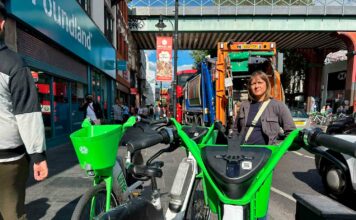 Woman poses for photo with e-bikes