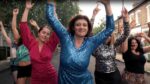 women dancing in street