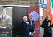 man speaking at public meeting