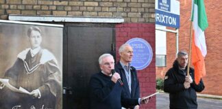 man speaking at public meeting