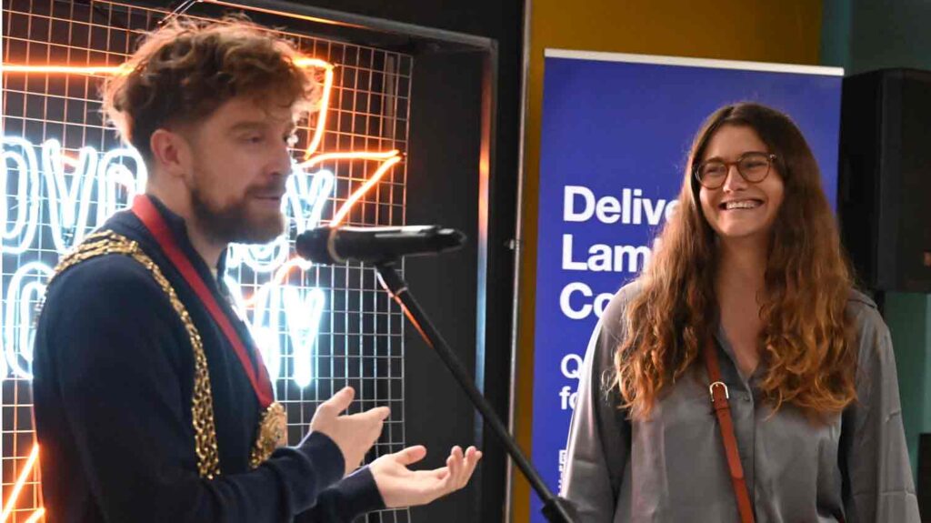 man and woman at public meeting