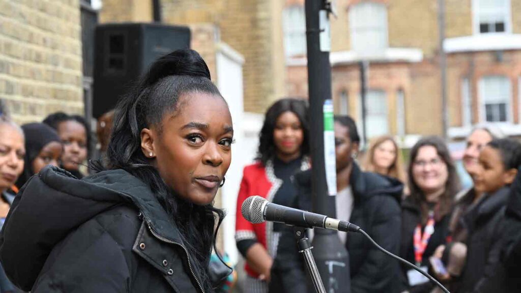 woman speaking at open air public meeting