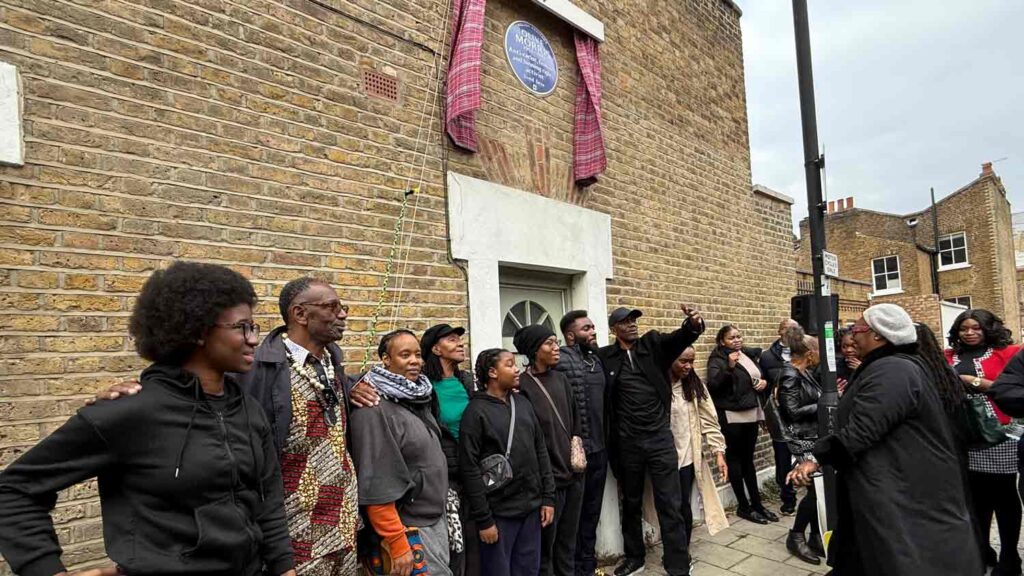 people pose for a photograph at a public ceremony