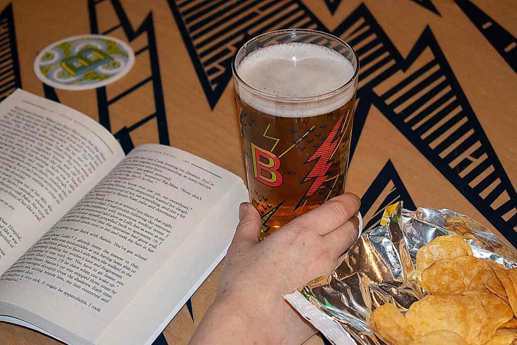 beer and book on table 