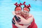 two women in swimming pool with antler headdresses