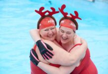 two women in swimming pool with antler headdresses