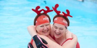 two women in swimming pool with antler headdresses