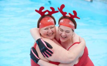 two women in swimming pool with antler headdresses