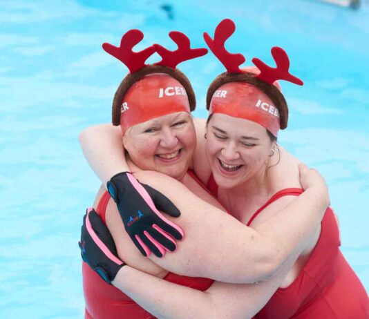 two women in swimming pool with antler headdresses