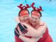 two women in swimming pool with antler headdresses