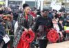 women with wreaths at public ceremony