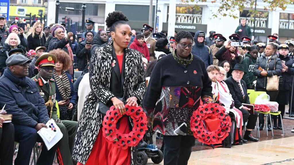 women with wreaths at public ceremony