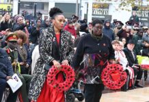 women with wreaths at public ceremony