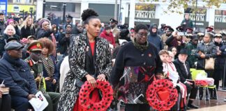 women with wreaths at public ceremony