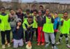 young footballers pose for photo