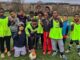 young footballers pose for photo