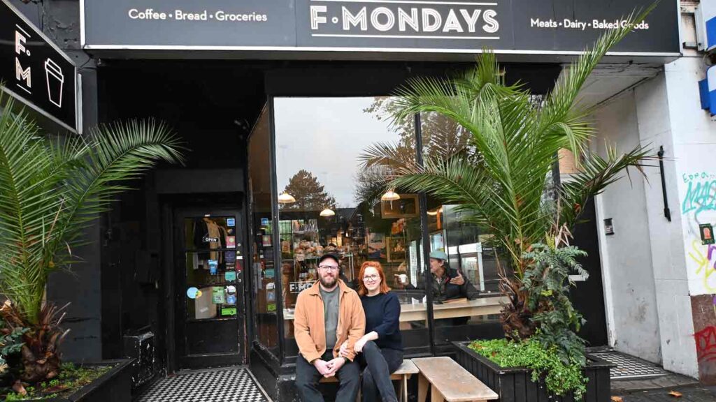 two people sit outside coffee bar